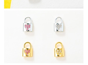 Detailed view of silver and gold heart lock pendants with pink and clear gemstones