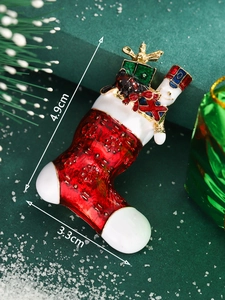 Macro detail of Christmas stocking brooch with nutcracker design and 4.9cm x 3.3cm size