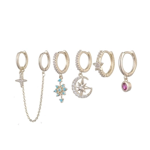 Detail of six-piece gold star and moon earring set featuring cubic zirconia and colorful gems