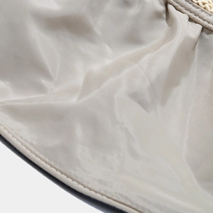 Macro detail of champagne nylon fabric and straw woven texture with white stitching