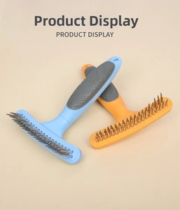 Dual-row metal teeth of pet grooming rake with non-slip rubber handles in blue and orange