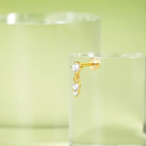 Detail of S925 sterling silver gold-plated ear stud with dangling clear zircon tassels