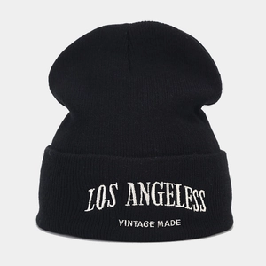 Macro detail of Los Angeles vintage letter embroidery on black knitted beanie cuff