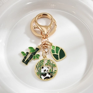 Cute panda and bamboo metal keychain with gold finish and green enamel pendants