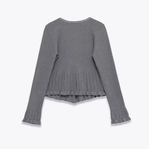 Close-up of grey ribbed knit top featuring delicate ruffle trim on sleeves and hem