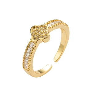 Gold plated clover open ring with white cubic zirconia stones on white background