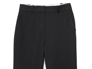 Detail of black dress pants featuring belt loops and side pockets with fine fabric texture
