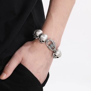 Vintage silver skull bracelet for men in gothic style worn on wrist with cross clasp