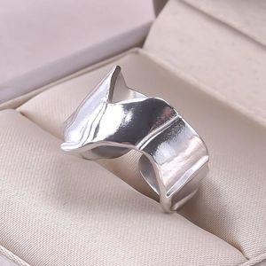 Macro detail of irregular wavy stainless steel ring with polished finish in jewelry box