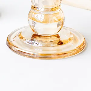 Detail of a stable round amber glass candle holder base with thick texture