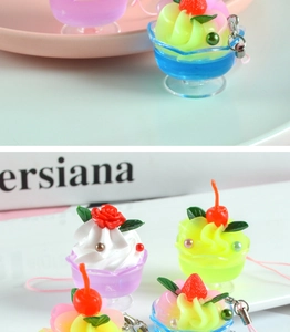 Detailed view of miniature fruit sundae pendants with colorful cream and strawberry charms
