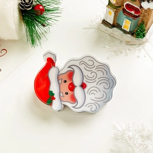 Close-up of Santa Claus tin box with holiday decorations and vibrant red festive colors