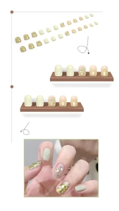 Detailed set of mint green press-on nails with sparkling glitter and emerald green rhinestones