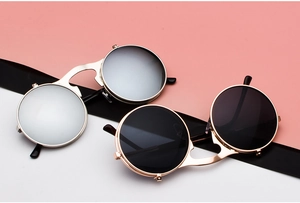 Close-up of steampunk flip-up sunglasses with round metal frames and double-layer lenses