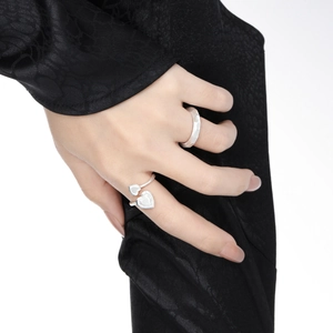 Silver double heart open ring and frosted wide band set on dark satin background