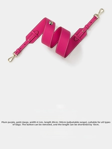 Detail of adjustable plum purple leather shoulder strap with gold metal buckles and clasps