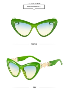 Macro view of green cat-eye sunglasses with blue-yellow gradient lenses and gold heart detail