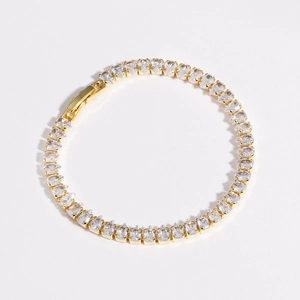 Detail of gold water-drop zircon tennis bracelet with intricate metal prong setting