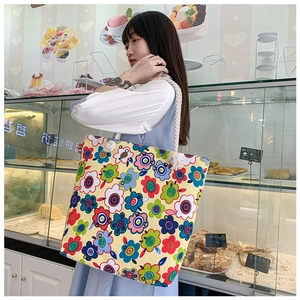 Detail of colorful floral printed canvas tote bag with thick white cotton rope handles