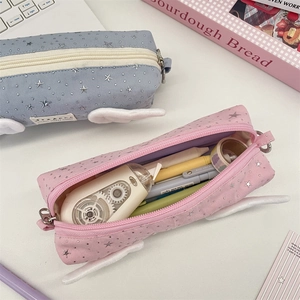 Detail of creative pencil cases with plush wings and silver stars for school storage