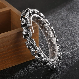 Dettaglio del bracciale punk con testa di serpente con maglie testurizzate e finitura argento