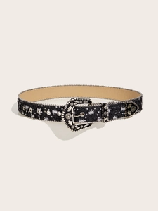 Close-up of black denim belt with silver western rivets and carved metal buckle