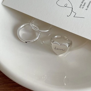 Detailed view of 925 sterling silver ring set with love engraving and heart signet