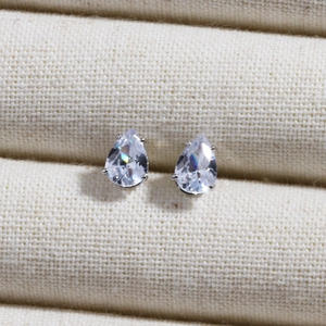 Macro detail of teardrop cubic zirconia earrings with silver-tone four-claw settings