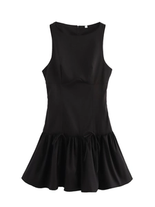 Detail view of a black sleeveless dress showing the hem ruffle and decorative bow tie