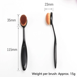 Toothbrush-shaped foundation brush with dense brown bristles and 115mm black handle