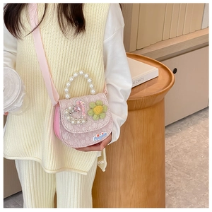 Pink heart-embossed kids crossbody bag featuring pearl handle and cute floral charms