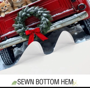 Detail of sewn bottom hem on Christmas fabric shower curtain with red truck design