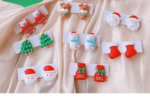 Selection of Christmas themed resin clip-on earrings featuring Santa and reindeer designs