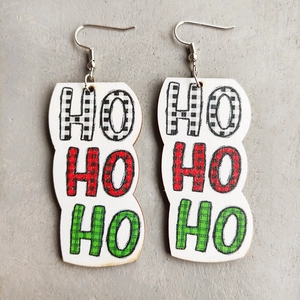 Detail of Christmas earrings featuring Ho Ho Ho text in festive red and green plaid patterns