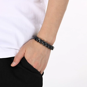 Close-up of matte black 11mm titanium steel Cuban link bracelet with chevron texture