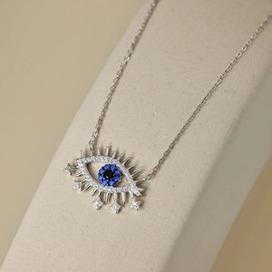 Detailed close-up of S925 sterling silver evil eye pendant with blue and white zircons