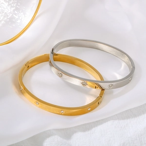 Polished 18K gold and silver stainless steel bangles with sparkling star-shaped engravings