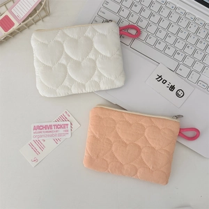 Detail of quilted heart patterns on candy-colored mini storage bags with zippers