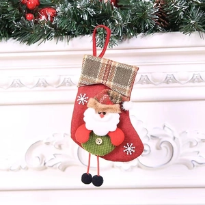 Detail of red burlap Christmas stocking with 3D Santa Claus and white snowflake embroidery