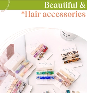 Close-up of three acetate hair clips with leopard and marble patterns on display cards