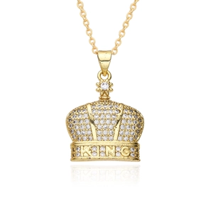 Close-up of gold crown pendant with king inscription and sparkling zircon pavé