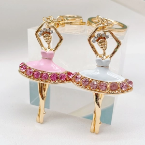 Detail of ballet girl keychains with pink and white rhinestone skirts in gold plating