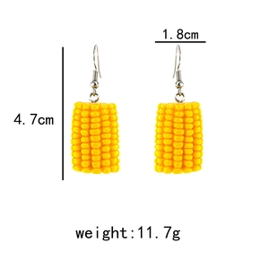 Detail showing corn-shaped drop earrings dimensions 1.8cm width and 4.7cm height