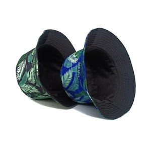 Tropical palm leaf bucket hats in black and blue with smooth fabric and flat top