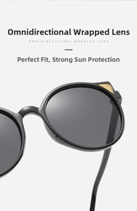 Close-up of black cat-eye sunglasses with golden metal accents and UV lenses