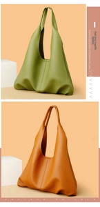 Detail of olive green and tan leather tote bags with premium lychee grain texture