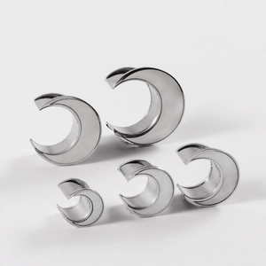 Moon shaped stainless steel ear gauges in various sizes with silver metallic finish