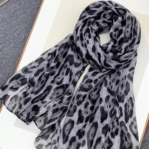 Stylish leopard print chiffon scarf in black and grey, displayed on a textured background