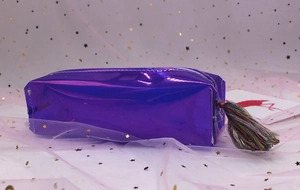 Close-up of a purple holographic pencil case with a colorful decorative silk tassel