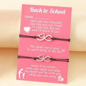 Two handmade back to school infinity heart bracelets on a pink gift card for students